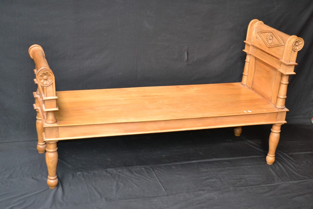 A scroll arm hardwood bench,