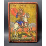 An Orthodox limewood icon, painted in colourful pigments with St.