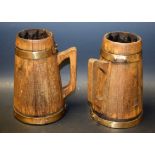 A pair of bound wooden ale tankards, tapering bodies,