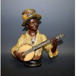 A Continental pottery model Blackamoor Banjo Player,