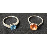 A sterling silver ring set with orange semi precious stone; another,