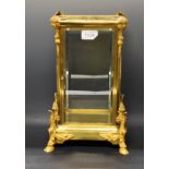 A late 19th century French ormolu clock case with four bevelled glass panels,