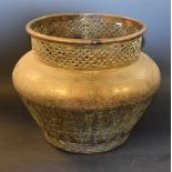 A Persian brass ovoid jardiniere, engraved with Arabic script, knot-pierced rim, 20cm high, c.