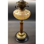 An early 20th century brass oil lamp, Loetz style glass reservoir,