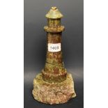 A serpentine lamp base modelled as a lighthouse,