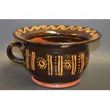 A 19th century style terracotta Slipware decorated chamber pot or spittoon