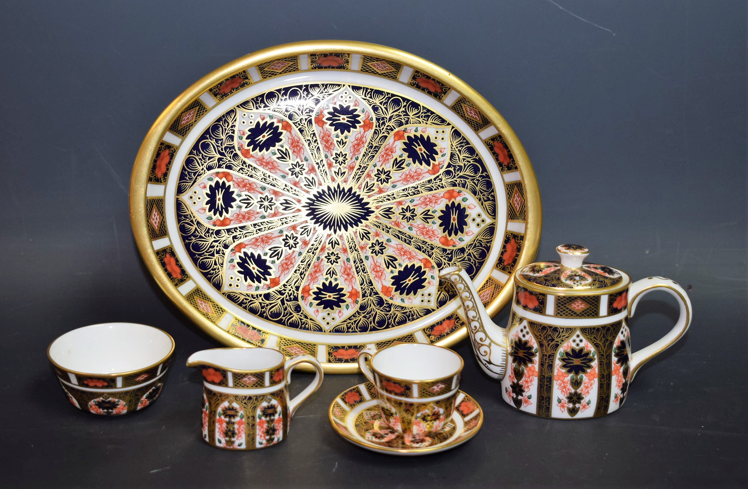 A Royal Crown Derby 1128 pattern miniature tea set on tray, coffee pot, cup and saucer,