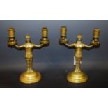 A pair of brass figural candlesticks,