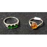 A sterling silver ring set with Baltic amber; another,