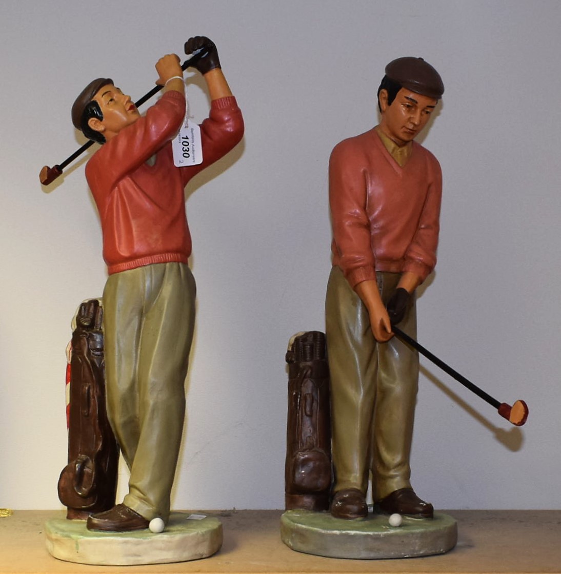 A pair of moulded chalk novelty golf player figures, approx.