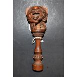 An Indian hardwood screw-action nutcracker, carved as a lion, the haft with lotus,