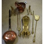 A late 19th/early 20th century three piece brass fireside companion set;