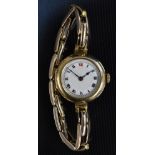 A ladies 9ct gold cased wristwatch, white enamel dial, bold Roman numerals, minute track,