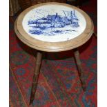 A Minton William Wise circular tile, set in to a tripod table with turned bamboo effect legs,