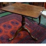 A 19th century rectangular oak tilt top tripod table