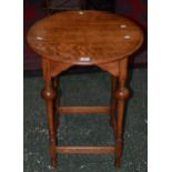 A light oak circular side table,