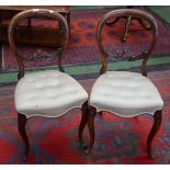 A pair of Victorian walnut cartouche back side chairs, deep-buttoned stuffed-over seats,