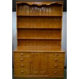 A Victorian Farmhouse scumbled pine dresser, shelves over a central cupboard door,