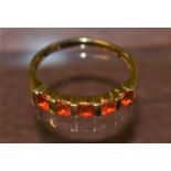 A QVC orange stone line ring, 9ct gold shank, 2.