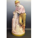 A large Royal Dux figure, of a boy by a water pump, he stands leaning on a coopered jug,