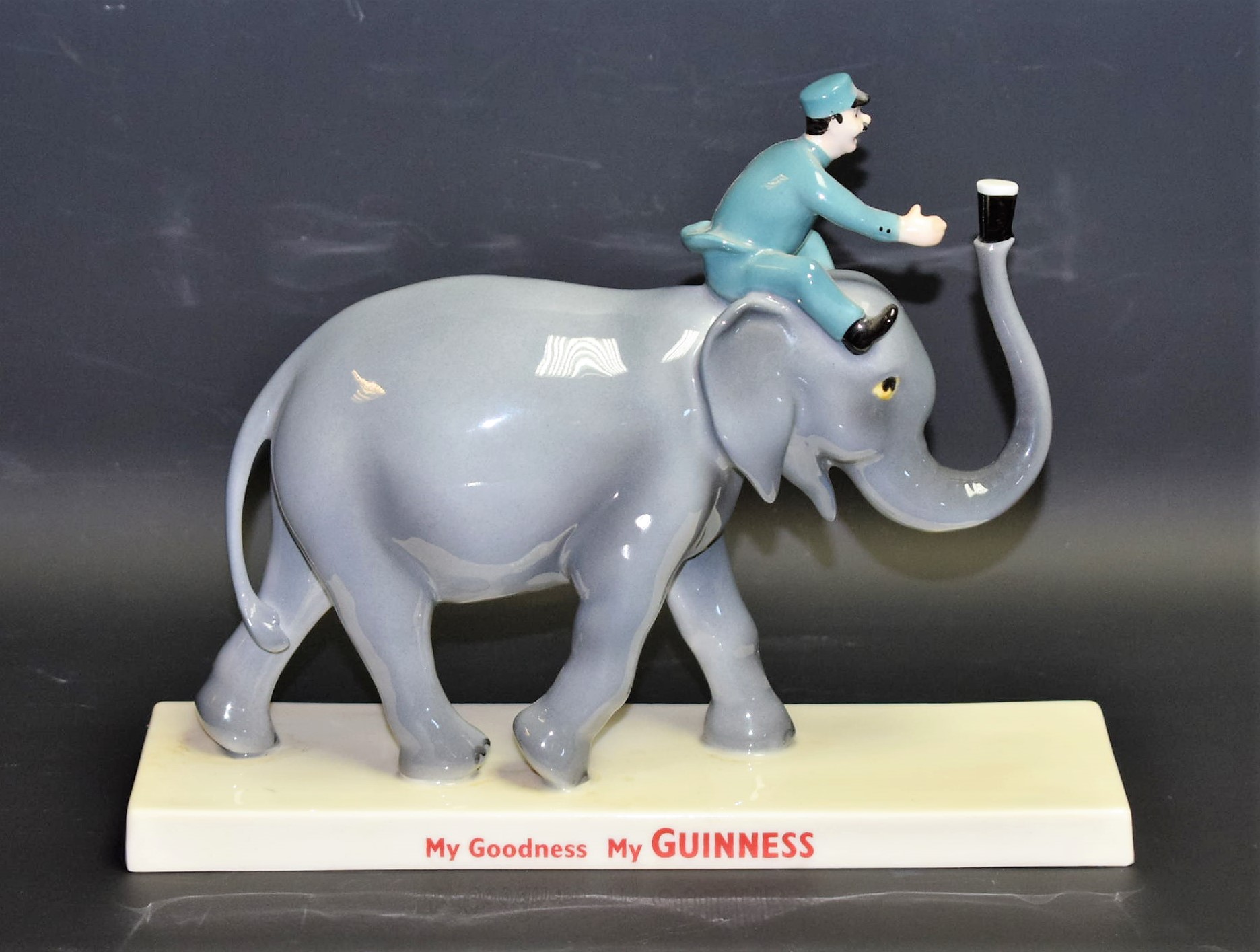 A Coalport ceramic advertising figure, Guinness Elephant and Keeper,