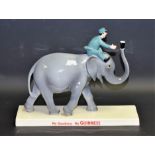 A Coalport ceramic advertising figure, Guinness Elephant and Keeper,