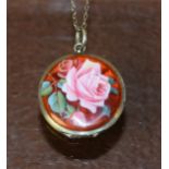 A white metal and enamel locket on chain,