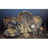 A silver plated cruet set stand with four cut glass bottles; an EPNS three piece tea service;