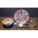 An 18th century Chinese tea bowl; a Japanese Imari plate; another, bowl; a cloisonné saucer,