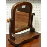 A mahogany dressing mirror of small proportions, arched mirror, shaped uprights, serpentine base,