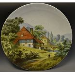 A continental hand painted charger depicting a Watermill in the mountains.