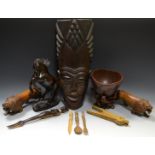 Tribal art - a carved face mask; two prowling lions; a figure of a horse rearing from a snake;