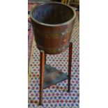 A brass bound coopered barrel jardiniere stand, three legs, triangular undertier.