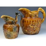 A substantial Woods treacle glazed ale jug decorated in relief with floral sprigs,