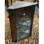 A mahogany splay front corner cabinet, astragal glazed door enclosing shelving. 91.5cm high x 64.