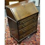 A George III small mahogany bureau, fall front over four drawers.