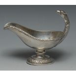 A Continental silver pedestal sauceboat, eagle's head handle, gadrooned rim,