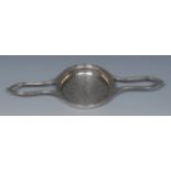 A George III silver lemon strainer, reeded borders, wide lug handles, pierced bowl, 29.