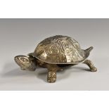 A George V novelty silver and cast metal clockwork counter top bell, cast as a tortoise standing,