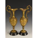 A pair of 19th century Etruscan Revival gilt bronze ewers,