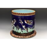 A large Joseph Holdcroft majolica jardiniere on stand, in relief with birds in flight,