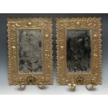 A pair of Arts and Crafts beaten brass girandoles,