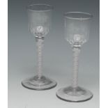 A pair of George III opaque twist drinking glasses, moulded bowls, double-helix cotton stems,