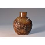 A Chinese hardstone flattened ovoid snuff bottle, carved in relief with a monkey holding a peach,