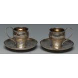 A pair of Chinese silver ogee coffee cups and saucers,