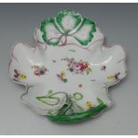 A Longton Hall leaf shaped dish, finely painted and moulded with heartese,