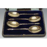 A suite of four George V silver Apostle fruit spoons, twisted stems, gilt bowls, 18.