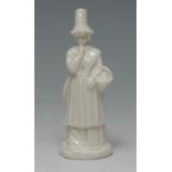 A W.H. Goss candle snuffer, in the white, of a Welsh lady in traditional dress, 9.