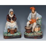 A pair of 19th century Majolica figures, of a fisherman and fisherwoman,