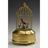 A 19th century style musical bird cage automaton, the singing avian perched on a branch,
